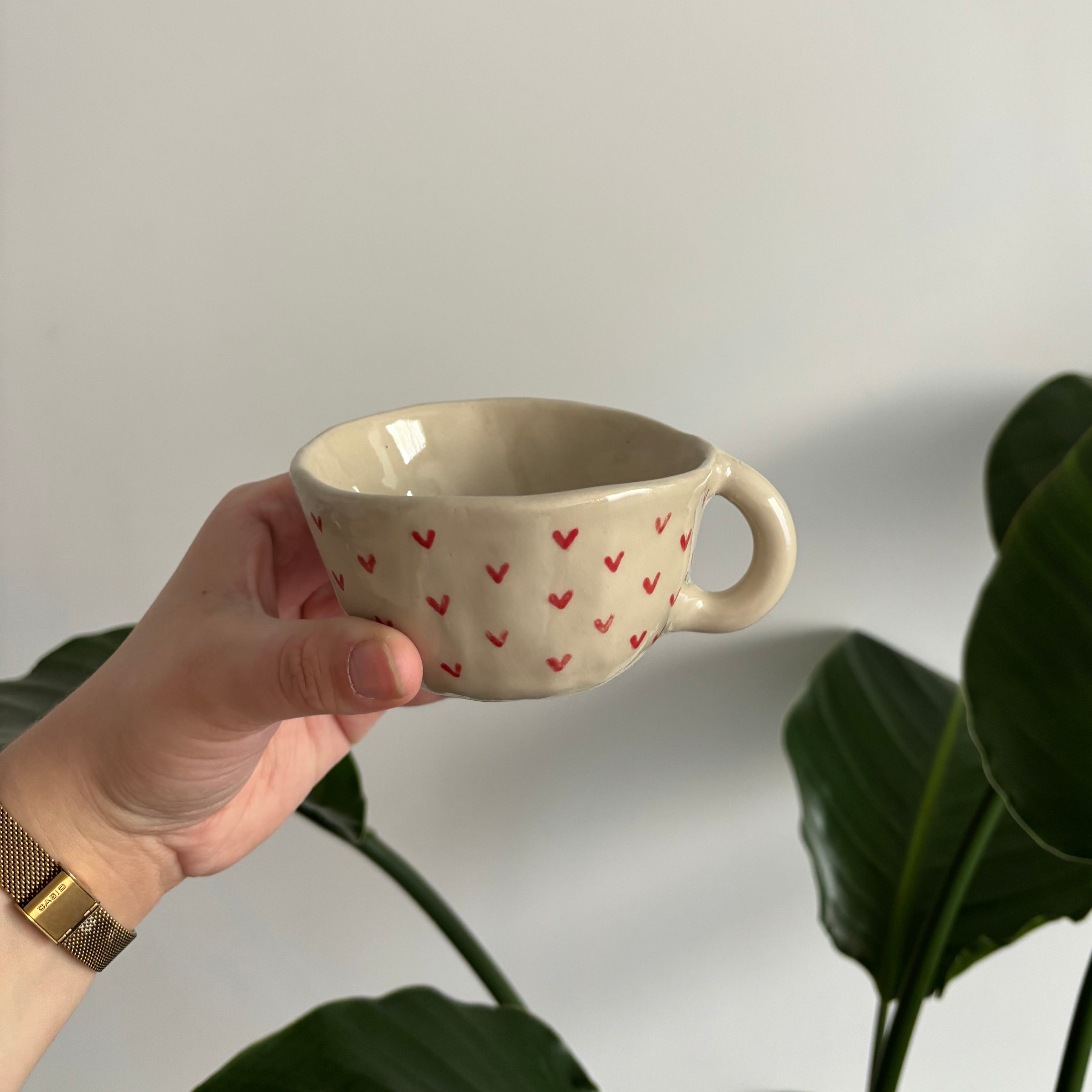 Tasse en céramique avec des cœurs rouges
